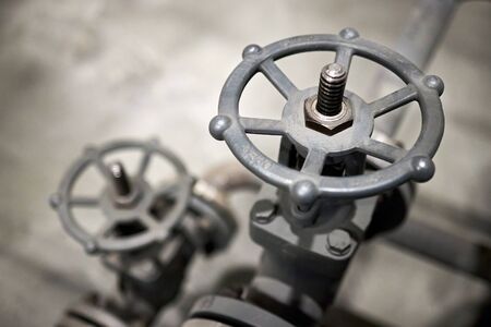 Close-up of industrial pair of valves with focus on foreground ventil with copy space.の写真素材
