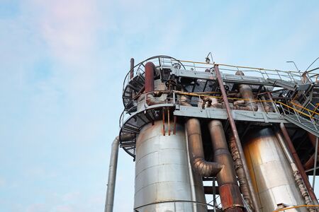 Oil refinery chemical plant bottom view with copy space against evening sky.の写真素材