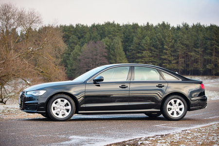 GRODNO, BELARUS - DECEMBER 2019: Audi A6 4G, C7 2.0 TDI 190 Hp 2016 facelift front outdoors on winter road during testdrive with forest on background.のeditorial素材