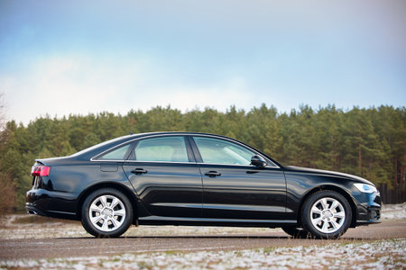 GRODNO, BELARUS - DECEMBER 2019: Audi A6 4G, C7 2.0 TDI 190 Hp 2016 facelift front outdoors on winter road during testdrive with forest on background.のeditorial素材