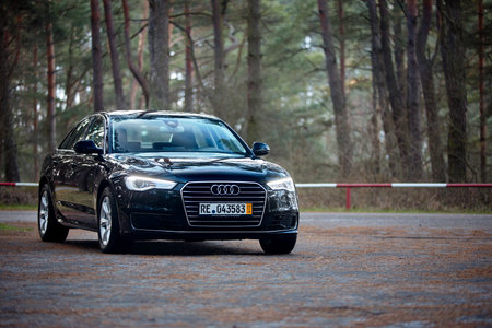 GRODNO, BELARUS - DECEMBER 2019: Audi A6 4G, C7 2.0 TDI 190 Hp 2016 facelift three fourth view outdoors on winter road during testdrive with forest on backgroundのeditorial素材