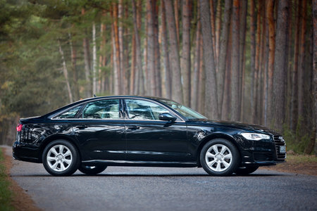 GRODNO, BELARUS - DECEMBER 2019: Audi A6 4G, C7 2.0 TDI 190 Hp 2016 facelift front outdoors on winter road during testdrive with forest on background.のeditorial素材