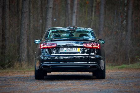 GRODNO, BELARUS - DECEMBER 2019: Audi A6 4G, C7 2.0 TDI 190 Hp 2016 facelift rear outdoors on winter road during testdrive with forest on background.のeditorial素材