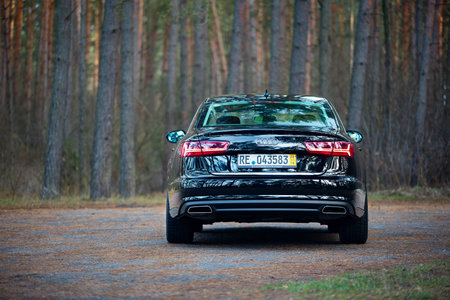GRODNO, BELARUS - DECEMBER 2019: Audi A6 4G, C7 2.0 TDI 190 Hp 2016 facelift rear outdoors on winter road during testdrive with forest on backgroundのeditorial素材