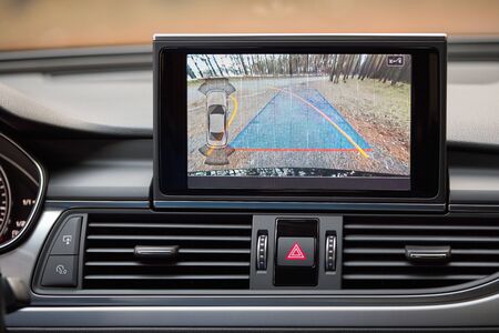 Interior with rear view camera dynamic trajectory turning lines and parking assistant steering wheel turned left.の写真素材