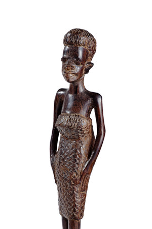 LUSAKA, ZAMBIA - NOVEMBER 2013: Typical examples of African art - African Statue of a Girl in a Dress Made of Mahogany Over White Knee Lengthのeditorial素材