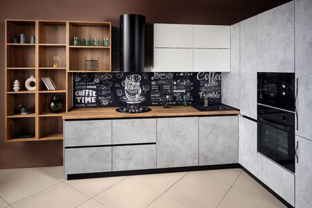Massive cottage urban rustic loft style kitchen interior in wooden finish and granite with chalk lettering on background.の写真素材