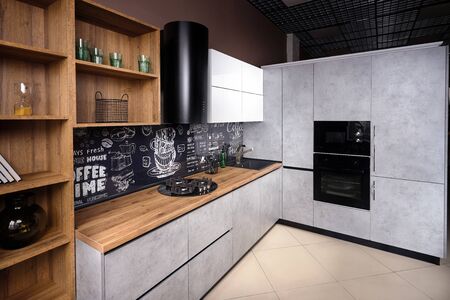 Massive cottage urban rustic loft style kitchen interior in wooden finish and granite with chalk lettering on background.の写真素材