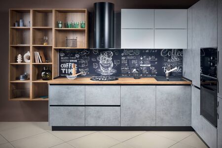 Massive cottage urban rustic loft style contemporary kitchen interior in wooden brushed oak table top gas hob fan and gray stoneware facade and granite sink, with chalk lettering background.の写真素材