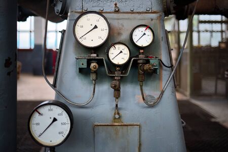 Example of chemical plant retro style equipment three pressure gauges or manometers shows zero closeup with out of focus abstract industrial background, with copyspace.の写真素材