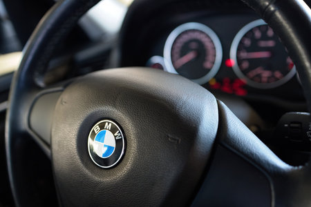 GRODNO, BELARUS - JUNE 2020: BMW X3 II F25 2.0i xDrive steering wheel with airbag and BMW logo with electronic dashboard, out of focus.のeditorial素材