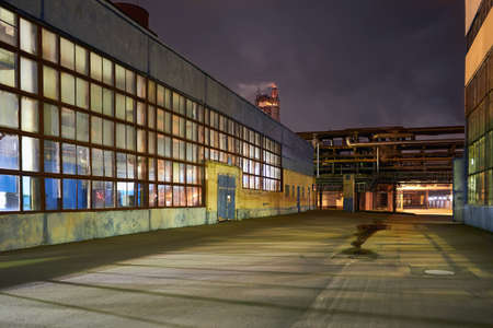 Night panorama of chemical plant building with dark blue sky. Compression buildings receding perspective with copyspace.の写真素材