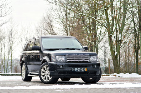 Grodno, Belarus, December 2012: Land Rover Range Rover Sport V8 Supercharged. Three quarter view of black SUV over out of focus winter park background with copy space.のeditorial素材