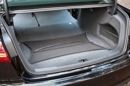 GRODNO, BELARUS - DECEMBER 2019: Audi A6 4G, C7 2.0 TDI 190 Hp 2016 facelift Clean, open empty transformated car trunk with safty mesh. Transformation of rear seats for carrying luggage in cabin.のeditorial素材