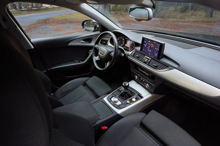 GRODNO, BELARUS - DECEMBER 2019: Audi A6 4G C7 interior in dark tones as example of technological equipment of modern vehicle display with GPS navigation map multimedia system climate control panels.のeditorial素材