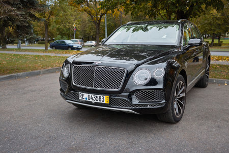 BERLIN, GERMANY - OCTOBER 2020: Bentley Bentayga Hybrid SUV luxury car three fourth left side front view outdoors parked on streets of Berlin in fall.のeditorial素材