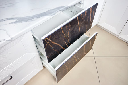 Two Kitchen Cabinet Door Drawers with Soft Quiet Closer Damper Buffers Cushion, solution to slow down closing action of cupboard, storage, cabinet and drawer protect from slamming reduce close noise.の写真素材