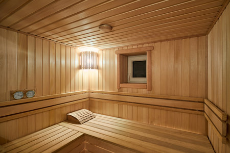 Russian sauna bathhouse with Linden Lining walls and ceiling Abash or African oak bench lanterns hygrometer thermometer for traditional rejuvenation recovery and restoration recreation of health.の写真素材
