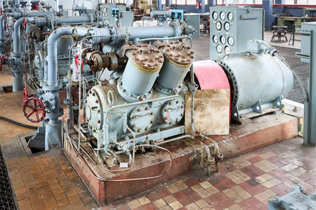 GRODNO, BELARUS - MAY 2020: Interior element of chemical enterprise ammonia reciprocating compressors with cylinders and electric motor with control panel, with control devices and alarm systems.のeditorial素材
