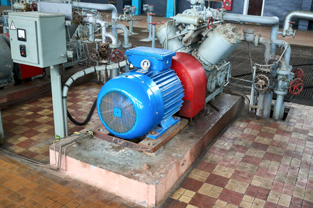 GRODNO, BELARUS - MAY 2020: Interior element of chemical enterprise ammonia reciprocating compressor with cylinders and electric motor with control panel, with control devices and alarm systems.のeditorial素材