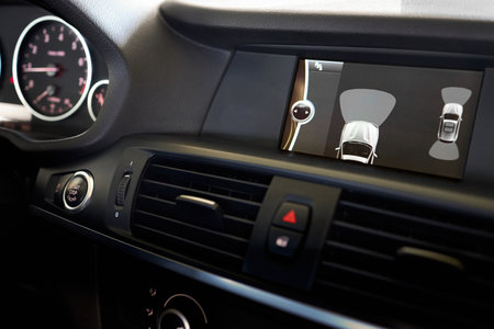 GRODNO, BELARUS - JUNE 2020: BMW X3 II F25 xDrive Premium car interior backup parking assistant system with sensors on screen with start stop engine and emergency buttons. Driver assistance systemのeditorial素材