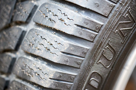 GRODNO, BELARUS - DECEMBER 2019: magnitude of winter tires tread depth concept Luxury car closeup alloy wheel with Dunlop winter tires side view with titanium look matt finish.のeditorial素材