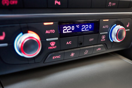 Modern car four zone automatic climate control panel for driver and passengers with air distribution, blower, seat heating, seat ventilation windows defroster defogger controls selective focus.の写真素材