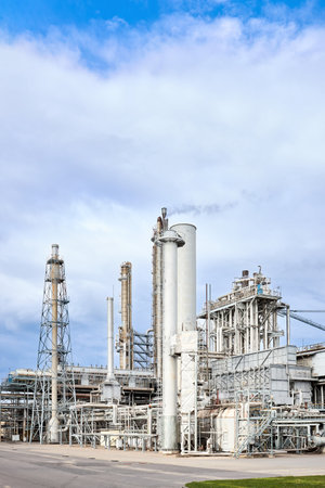 Large-capacity ammonia production workshop. Exterior of modern petrochemical plant with reactors and converters under heavy sky with copyspace vertical.の写真素材