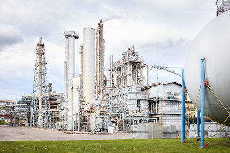 Large-capacity ammonia production workshop. Exterior of modern petrochemical plant with reactors spherical gasholder and converters under heavy sky with copyspace.の写真素材
