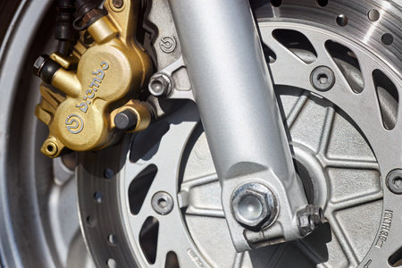 Berlin - April 2021: Front disc brakes BREMBO of race bike Honda closeup. Front radial mount caliper sport bike, Motorcycle with Twin Floating Disk Brake and ABS system with copyspaceのeditorial素材