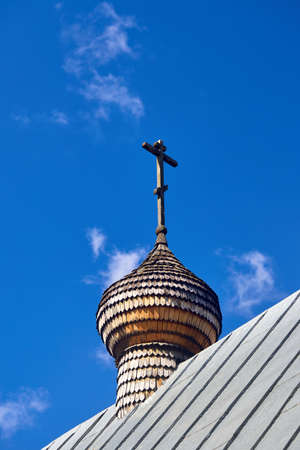 Wooden dome with orthodox cross of Church of the Beheading of St. John the Baptist in European city Grodno or Hrodna Belarus on blue sky background with cirrus clouds with copyspace.の写真素材