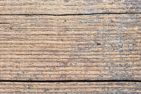 Old sandy weathered washed tainted wood texture with horizontal cracks and grains of river sand. Natural textured closeup dry plank background.の写真素材