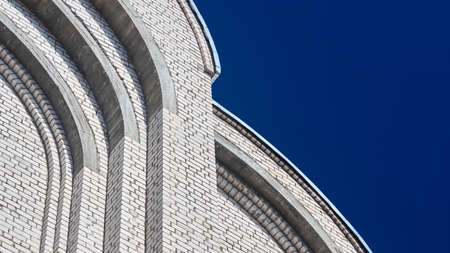 Architecture construction detail closeup domed element of orthodox church temple zakomara concha arch made of brick and concrete under construction of facade architectural background with copyspace.の写真素材
