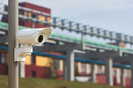Security system of modern petrochemical plant chemical factory surveillance system CCTV camera operating to prevent theft accidents explosions catastrophes and industrial espionage with copyspace.の写真素材