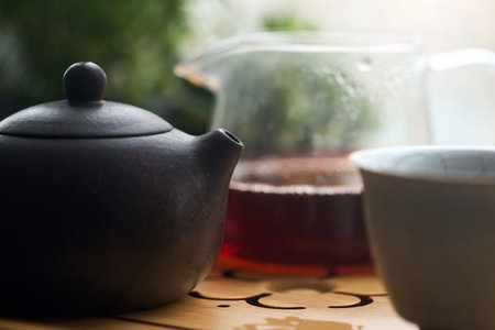 Tea ceremony gong fu cha. Selective focus. Handmade purple yixing zisha clay chinese teapot with shu...