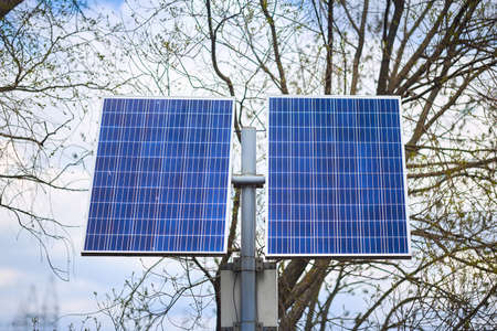 Solar battery generates clean green energy for lanterns in public park front view. Concept of environmental conservation, combating pollution and greenhouse effect innovations and new technologiesの写真素材
