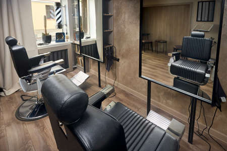 Barber shop or barber shop vintage design hair man salon empty with two chairs and two mirrors and accessories.の写真素材