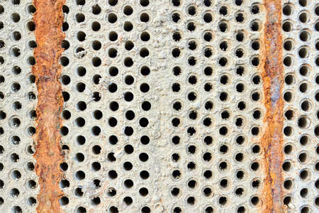 Selective focus tube sheet or boiler or plate of heat exchanger closeup texture macro background full of hard insoluble mineral deposits salts scale and corrosion. Trypophobia concept.の写真素材