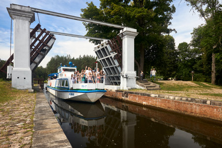 Grodno - August 2021: boat Neman with tourists enters Dombrovka lock on Augustow Canal, Avgustovski channel or Kanal Augustowski protected by UNESCO in Grodno Hrodna visafree region Belarus in Europe.のeditorial素材