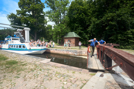 Grodno - August 2021: Dombrovka lock workers open dam and gate manually for Neman boat passage on Augustow Canal, Avgustovski channel or Kanal Augustowski in Grodno Hrodna region Belarus in Europe.のeditorial素材