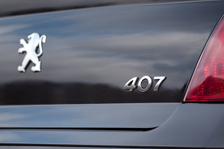 Berlin - April 2014: Peugeot 407 2003-2010 sedan pre facelift selected focus rear view of digit number logo sign of Peugeot 407 with car trunk opening button.のeditorial素材