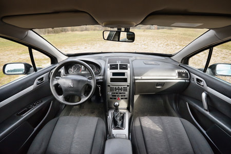 Berlin - April 2014: Peugeot 407 2003-2010 sedan pre facelift interior dashboard cockpit steering wheel front seat and mechanic manual transmission gearbox.のeditorial素材