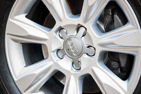 GRODNO, BELARUS - DECEMBER 2019: Audi A6 4G C7 Luxury car detailing closeup alloy wheel with winter tires side view with titanium look matt finish with caliper brake system.のeditorial素材
