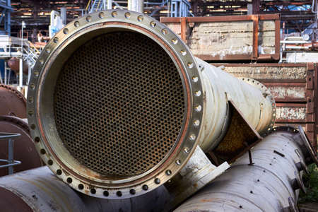 Industrial heat exchanger or boiler tubes bundle. Dismantled heat exchanger shell and tubes with deposits and corrosion at petrochemical enterprise, industrial background with copyspace.の写真素材