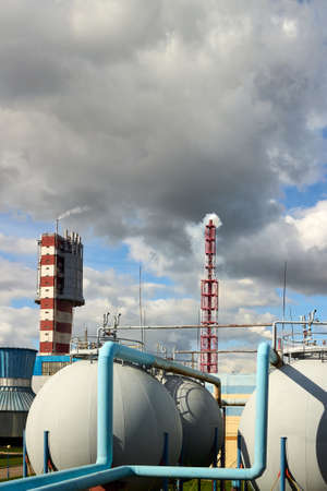 Tower granulator chimney cooling tower and spherical gas tank gasholder petrochemical equipment for production of urea compound granular fertilizer. Chemical plant vertical background with copyspace.の写真素材