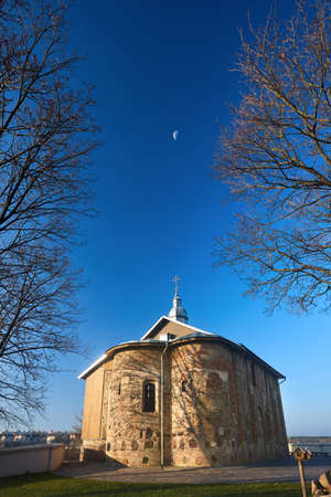 Kalozha church in Grodno Belarus. St Boris and Gleb or Kalozhskaya church early autumn morning under deep blue sky with Moon wide vertical shot in Eastern Europe visafree city Grodno Hrodna Belarus.の写真素材