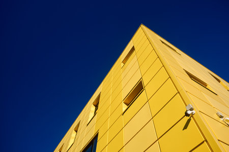Aluminum composite panels for repair restore facade of commercial building construction with CCTV camera security video system wide angle view with copyspace conceptual minimalism.の写真素材