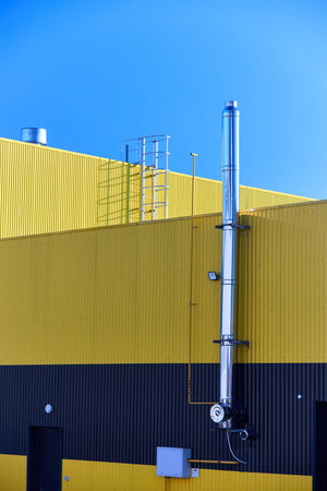 Aluminum composite panels yellow and blue commercial building facade with stainless steel chimney...