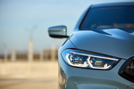 Berlin - October 2021: BMW 8 Series G16 Gran Coupe 840i xDrive M-pack 2021. Front view selective focus detailing with front BMW laser LED headlight, parking sensor and camera bumper and grill closeup.のeditorial素材
