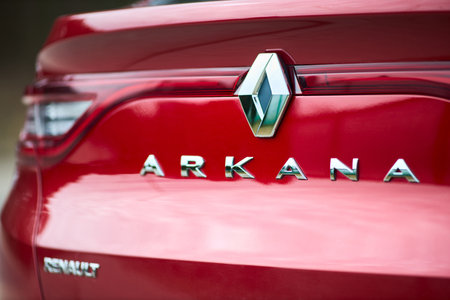 Berlin - March 2022: 2021 Renault Arkana e-Tech hybrid SUV car Renault and Arkana logo selective focus car detailing with trunk lid badge emblem.のeditorial素材